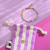 Perlenarmband bunt smile, mit Karabinerverschluss und Säckchen in brombeer/weiss